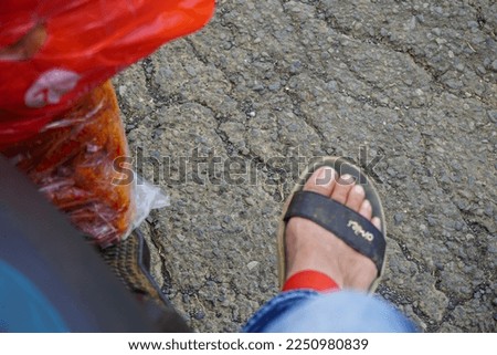Stock photo of sandals and shoes being worn