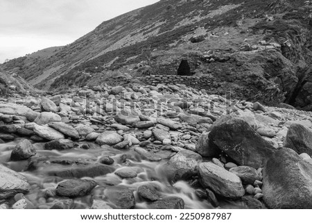 Long exposure of the river Heddon flowing onto the beach at Heddons Mouth in Exmoor