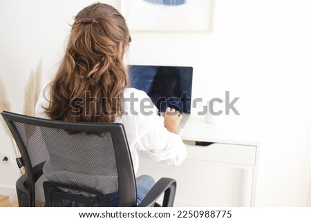 Woman Working from Home Office on her Desk Royalty-Free Stock Photo #2250988775