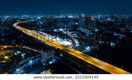 Expressway top view, Road traffic an important infrastructure, Drone aerial view fly in circle, traffic transportation, Public transport or commuter city life concept of economic and energ, transport. Royalty-Free Stock Photo #2251004149