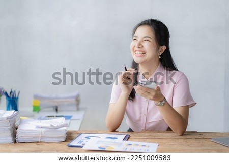Asian businesswoman working with calculator to analyze business data and financial concept Female accountant working with computer and for business and financial expenses charming asian girl