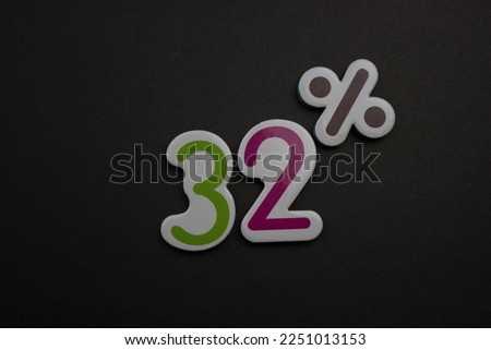 Colorful 32 percent inscription placed on a black background.