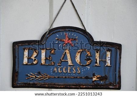 Old rusted Beach access sign 
