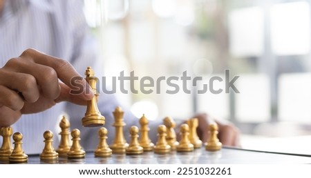 Businessman moving gold Chess King figure and Checkmate opponent during chessboard competition. Strategy, Success, management, business planning. Concept of business strategy and tactic. Royalty-Free Stock Photo #2251032261
