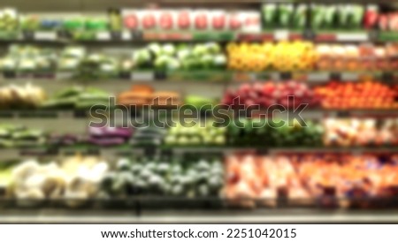 Abstract blur background of supermarket aisle shelves chilled vegetable zone.