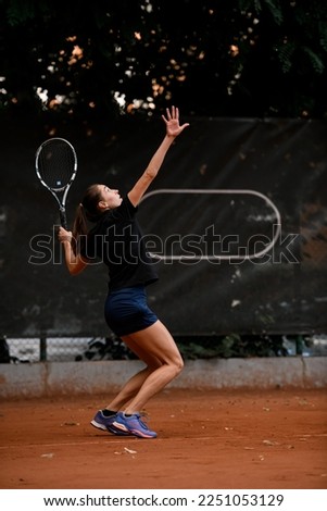 gorgeous view of active sporty woman tennis player with tennis racket in hand doing pitch