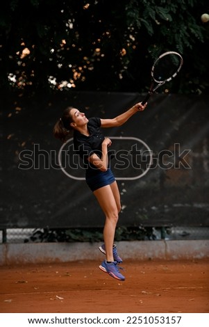 wonderful shot in motion of sports female tennis player with tennis racket in her hand before to hitting ball