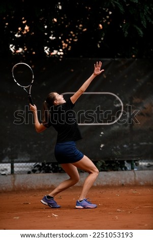 great view of active sporty woman tennis player with tennis racket in hand doing pitch