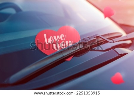 Red heart with text I love you. Paper heart on the windshield of the car under the brush. The concept of a declaration of love or holiday Valentine's Day. Close-up Royalty-Free Stock Photo #2251053915