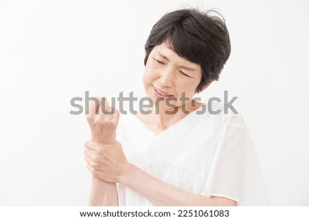 Asian senior woman having the joint pain in white background