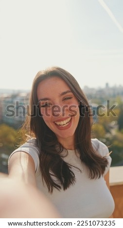 Close-up of young woman taking selfie hand peace sign while standing on balcony Royalty-Free Stock Photo #2251073235