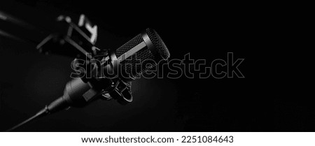professional sound recording microphone on black background. banner with copy space Royalty-Free Stock Photo #2251084643