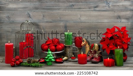 vintage christmas decorations with red candles, flower poinsettia, stars and baubles. dark designed picture