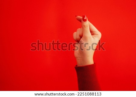 The Korean symbol for love is obvious. A woman's hand covers a heart. Place for text. Happy Valentine's day Royalty-Free Stock Photo #2251088113