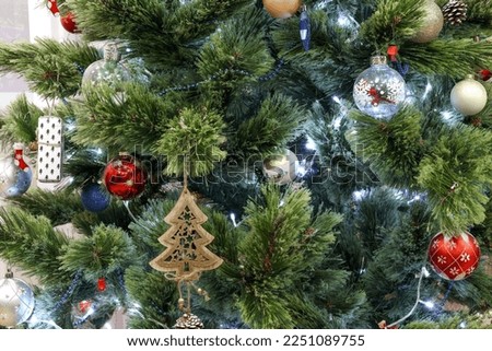 The elegant fir tree is decorated with cute various Christmas toys