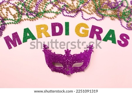 Mardi Gras concept with beads and carnival mask. Mardi Gras holiday celebration.
