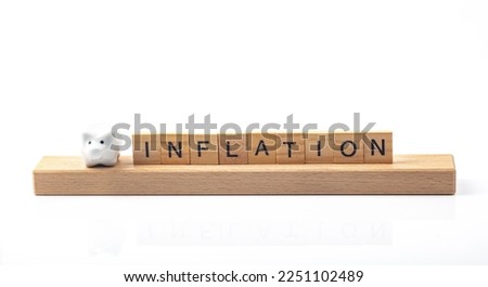 Inflation concept with letters and little piggy bank isolated ober white background