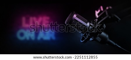 live on air. radio podcast broadcasting studio microphone with neon lights sign. banner with copy space Royalty-Free Stock Photo #2251112855