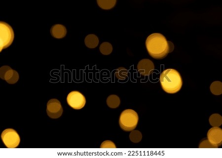Abstract background of blurred yellow lights for design. Lights bokeh dis focus. Festive background, copy space