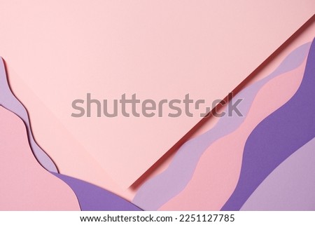 Abstract colored paper texture background. Minimal paper cut composition with layers of geometric shapes and lines in pastel pink and violet purple colors. Top view, copy space