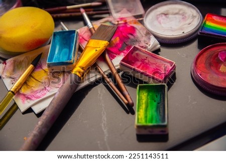 Professional make-up tools. Palettes of paints, shadows, makeup brushes. Paints and brushes for watercolor painting.
