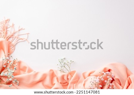 Hello spring concept. Top view photo of pink soft plaid and gypsophila flowers on isolated white background with copyspace