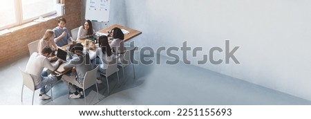 Wide Horizontal Banner With Multiethnic Business Team Discussing New Project In Office, Extended Shot Of Young Multicultural Colleagues Having Meeting In Boarding Room, Panorama With Copy Space Royalty-Free Stock Photo #2251155693