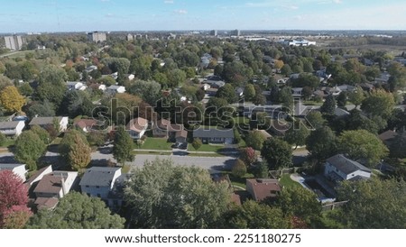 Flying Sideways Over Houses With Autumn Trees Royalty-Free Stock Photo #2251180275