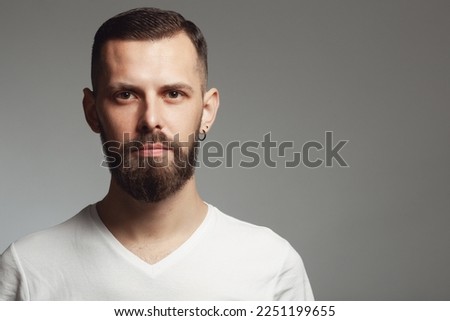Male beauty concept. Portrait of proud charismatic active 30-year-old man posing over gray background. Perfect haircut. Hipster style. Copy-space. Close up. Studio shot Royalty-Free Stock Photo #2251199655