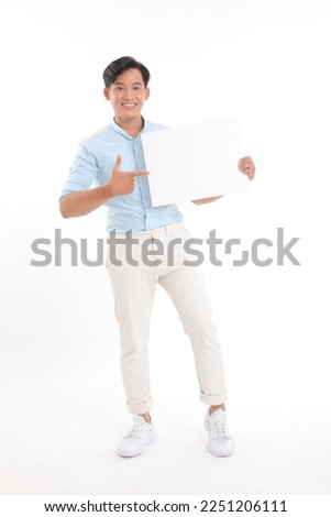 Full length body photo of a young handsome cheerful smile adult man, hold a blank empty white card with copy space to write message on, isolated on white background. Concept of promote a content.