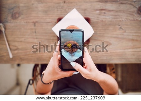 Woman, phone screen and taking photograph of coffee shop, restaurant and bistro for social media post, influencer food review and social network blog. Above of girl, smartphone and cafe drink picture