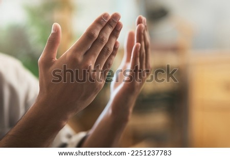 Surrender everything that weighs you down. Shot of a unrecognizable muslim man praying in the lounge at home. Royalty-Free Stock Photo #2251237783