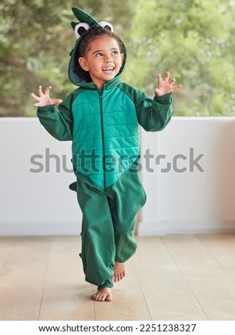 Child, smile and excited in halloween dinosaur costume at home playing role and having fun at party. Happy kid being playful with fantasy character in living room mimic animal actions ready to roar. Royalty-Free Stock Photo #2251238327
