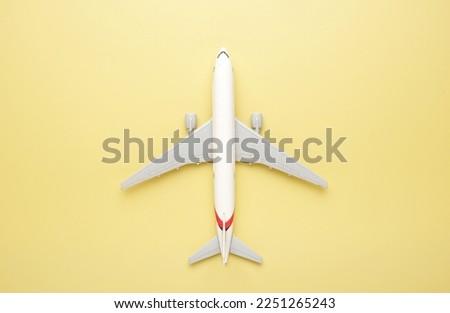 A picture of toy airplane on yellow background