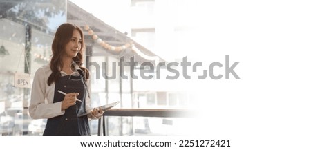 Young asia business owner woman with apron with open sign at café, open again