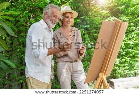 Portrait happy senior couple caucasian artist mature man  woman paint with water color outdoor greenery class. Old creative gifted artist class work shop school education. Activity hobby lifestyle. 