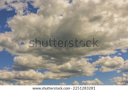 Close-up view of puffy white clouds on blue sky background. Beautiful nature backgrounds concept. 