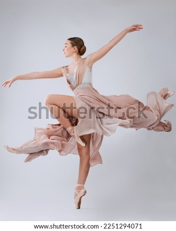 Woman dancing, ballet and studio background with balance, art movement and beauty for training. Professional dancer, performance and finesse in class with strong body, wellness and focus for concert Royalty-Free Stock Photo #2251294071