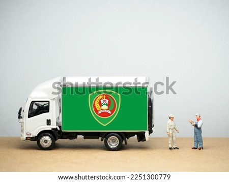 Mini toy at table with white background. Industrial shipping concept. Aceh flag, officially the Aceh Province (Indonesian: Provinsi Aceh) is the westernmost province of Indonesia.