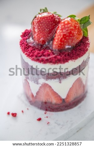Red cake with strawberries. Strawberry dessert with cream. Sweet strawberry pie isolated on white.