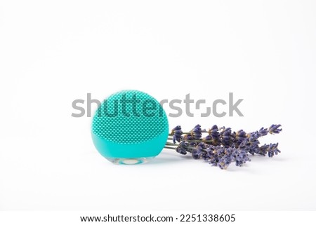 Mint colored facial cleansing brush isolated on white background. Cosmetic accessory. Beauty concept.
