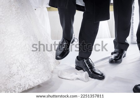 Orthodox Jewish wedding, traditional ritual of groom stamping on glass. Remembrance of Jerusalem. Wedding day ritual. Royalty-Free Stock Photo #2251357811