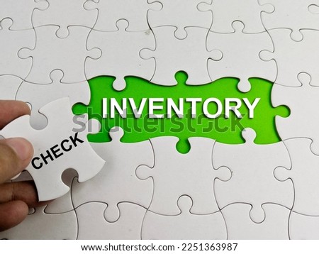 word of INVENTORY and Check concept with a missing jigsaw puzzle in green background