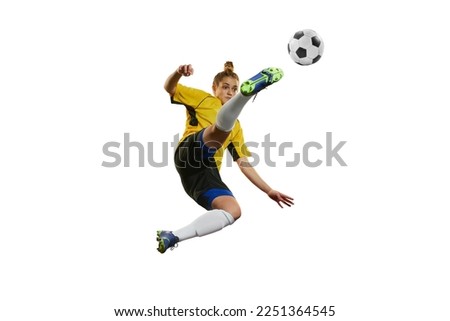 Hitting ball in a jump. Young professional female football, soccer player in motion, training, playing isolated over white background. Concept of sport, action, motion, goals, competition, hobby, ad.