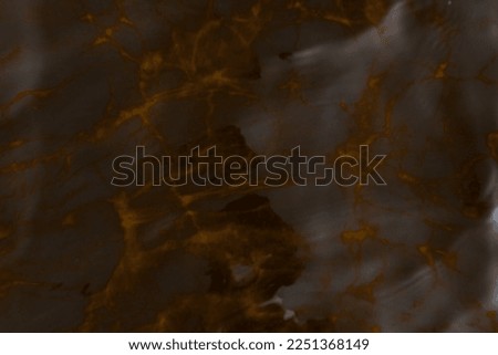 Texture of light reflections from the transparent surface of the water and waves in brown tones. Background. Abstraction.