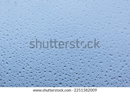 Water drops on white and blue background, with a slight blurred and gradient effect. Royalty-Free Stock Photo #2251382009
