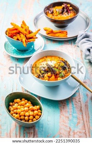 Carrot and sweet potato soup with chickpeas and fresh winter herbs, sweet potato fries
