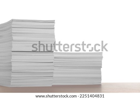 Stacks of paper sheets on wooden table against white background. Space for text Royalty-Free Stock Photo #2251404831