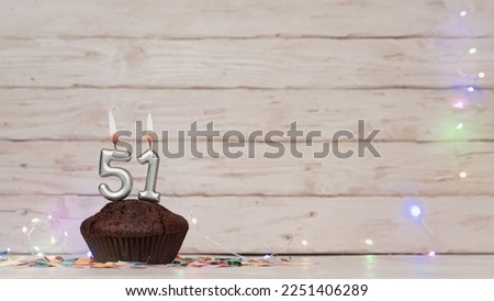 Festive card Happy Birthday with number of burning candles. Beautiful background copy space, happy birthday with digit number 51