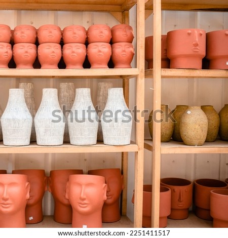 Display of decorative plant vase art shaped like a human head at a gallery in Jakarta Royalty-Free Stock Photo #2251411517